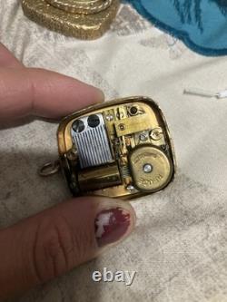 Reuge Swiss-made music box pendant with an ornate gold-plated blue cameo front