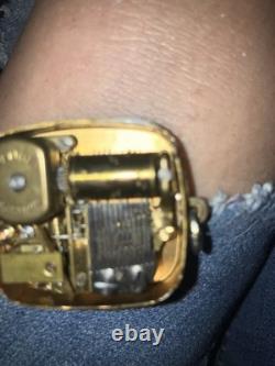 Reuge Swiss-made music box pendant with an ornate gold-plated blue cameo front