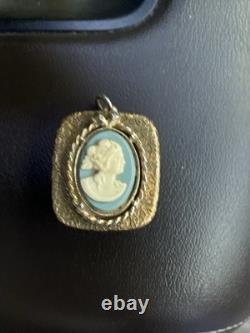 Reuge Swiss-made music box pendant with an ornate gold-plated blue cameo front