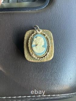 Reuge Swiss-made music box pendant with an ornate gold-plated blue cameo front