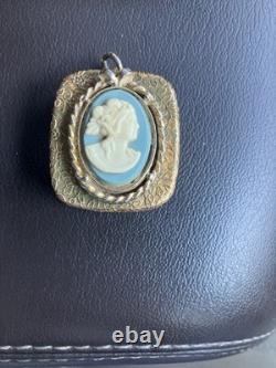 Reuge Swiss-made music box pendant with an ornate gold-plated blue cameo front