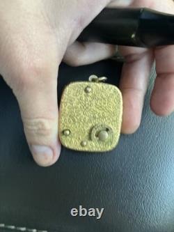 Reuge Swiss-made music box pendant with an ornate gold-plated blue cameo front