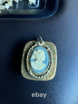 Reuge Swiss-made music box pendant with an ornate gold-plated blue cameo front